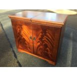 A mahogany hostess trolley, with sliding top enclosing glass tureens, with heated cupboard below,