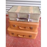 Two tan leatherette graduated suitcases; and a Revelation canvas suitcase. (3)