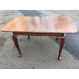 An oak draw-leaf dining table