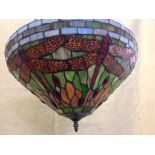 A tiffany style hanging light with leaded glass shade in the dragonfly pattern,