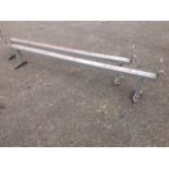 A pair of metal vehicle roof-rack bars; and three trailer lighting bars with cables. (4)