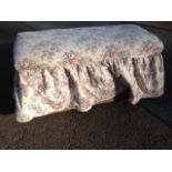 An upholstered ottoman, the pine box with padded lining lifting lid decorated with floral covers.