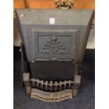 A cast iron stone cover with decorative panel to front; and a grate front with grill bars