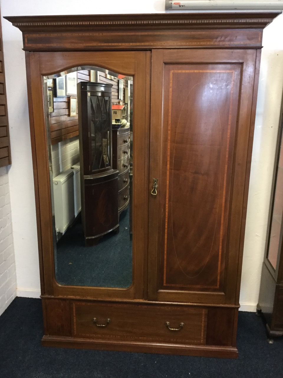 An Edwardian mahogany wardrobe inlaid with satinwood banding