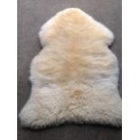 A lambskin wool rug. (40in x 23in)