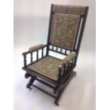 An American rocking chair with floral upholstered tapestry seat & back