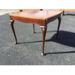 A walnut draw-leaf dining table