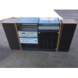 A Ferguson hi-fi system in cabinet with turntable, cassette deck, stereo tuner, & two tall speakers.