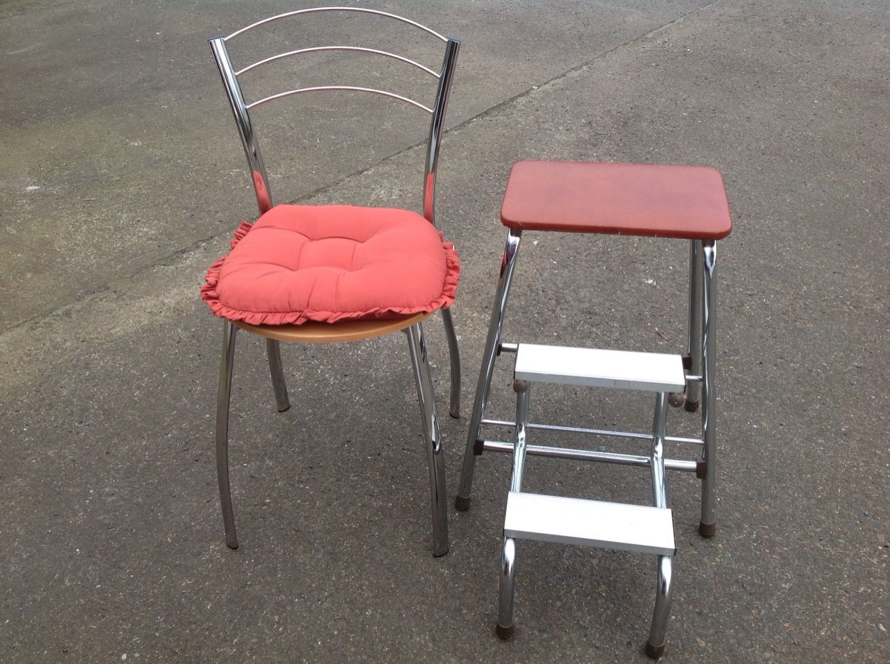 A contemporary chrome chair with circular beech seat, fitted with loose cushion; and a chrome stool