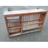 A Victorian hanging pine plate rack with spindle dividers to various shelves.