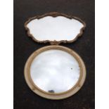 A circular convex mirror in painted and gilded ribbon moulded frame; and a rococo style gilt mirror