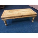 A pine coffee table with rectangular panelled slatted top having iron mounts to chanelled frieze.