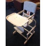 A childs rocking chair, having stud and upholstered padded back