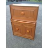 A 70s teak bureau with panelled fallfront enclosing an interior with pigeonholes and small drawer,