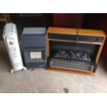 A Delonghi Dragon 3 electric oil heater on casters; a Superser portable gas heater; and a Dimplex