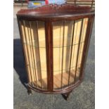 A mahogany D Shaped china cabinet.