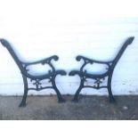 A pair of cast iron bench ends, with scrolled supports to arms, having chanelled frames. (2)