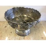 A large silver plated punch bowl embossed with vine frieze, raised on socle base complete with ladle