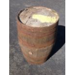 A large 3ft oak barrel, the staves bound by six metal bands.