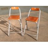 A pair of modern folding kitchen chairs / stools, with wood backs & seats on tubular frames