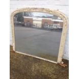 A Victorian overmantle mirror, the arched plate in painted gesso mounted frame.