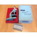 A boxed Britax Pioneer II microscope, with a set of prepared slides. (2)