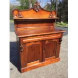 A reproduction mahogany chiffonier with pierced moulded carved crest