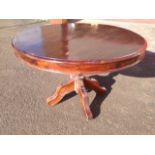 A circular mahogany dining table
