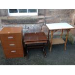 A modern chest of three drawers; a nest of tables with shaped legs