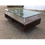 A contemporary coffee table, with rectangular plate glass