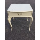 A painted bowfronted bedside cabinet, with moulded top above frieze drawer, raised on cabriole