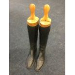 A pair of black leather riding boots, size 7, complete with beech trees.