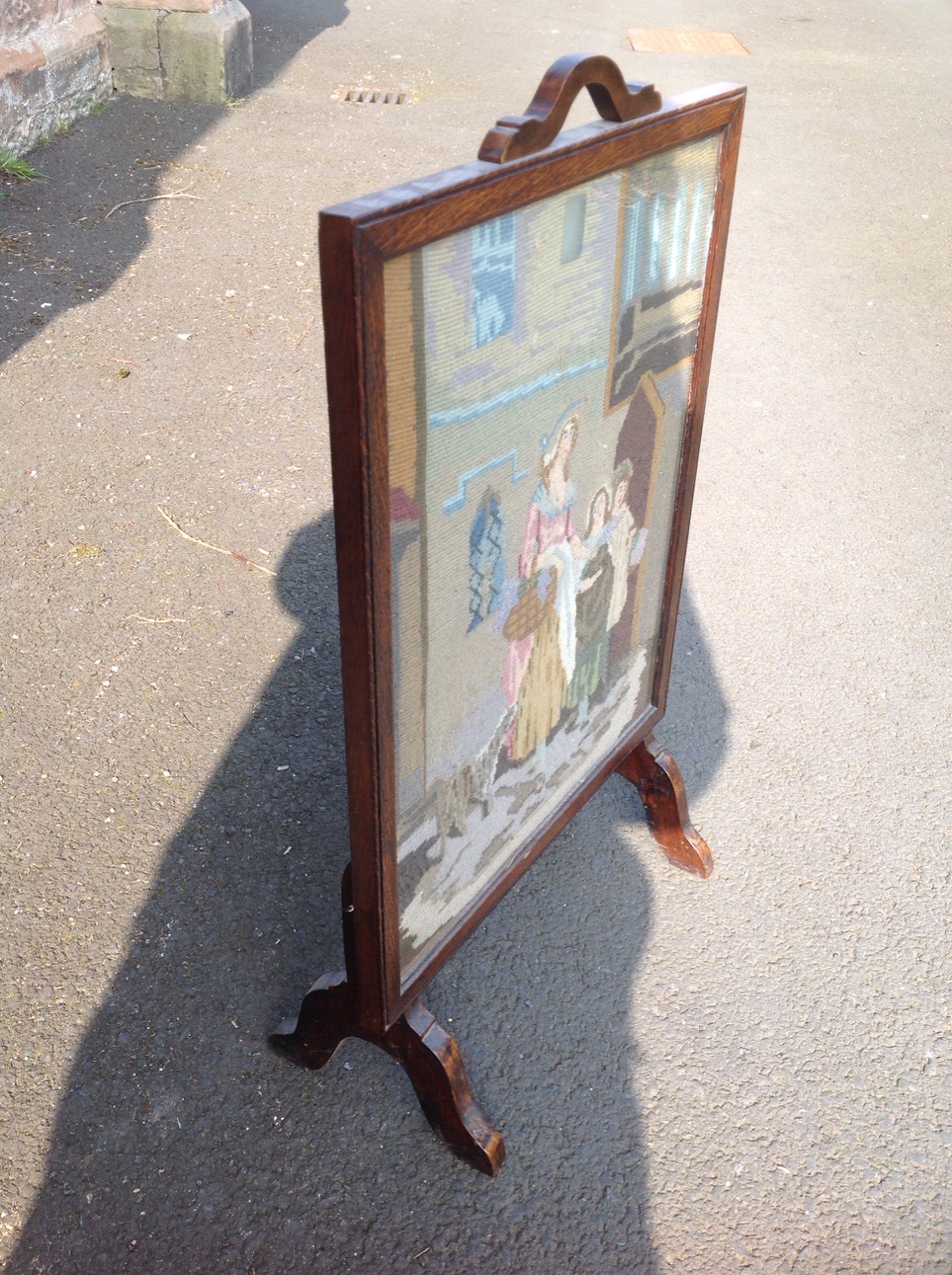 An oak firescreen, the woolwork tapestry panel depicting a mother with her children & dog. - Image 3 of 3