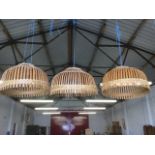 A set of three circular cane domed lampshades. (3)