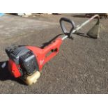 A Mountfield MT22CX petrol strimmer, the machine with spare line spools.