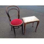 A rectangular dressing table stool with upholstered padded seat