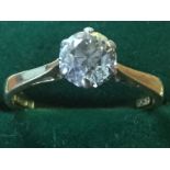 A 18ct solitaire diamond ring, the claw set stone in scrolled mount of approx 0.75 carats,