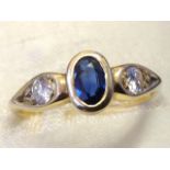 An 18ct hallmarked gold sapphire & diamond three stone ring, the circular bezel set brilliant cut