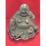 A nineteenth century bronze Buddha, the seated smiling figure on shaped wood stand. (11in x 9.5in)