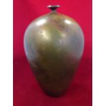 An egg shaped vase with waisted neck and flared rim, the vessel with brown, green, gold and amber