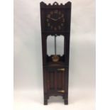 An arts & crafts oak longcase style clock, the case of pegged construction housing an American