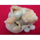 A nineteenth century carved jade lion & cub. (4in)