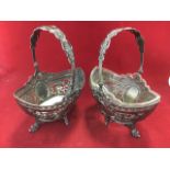 A pair of Victorian hallmarked silver baskets, with foliate pierced panels framing oval scrolled