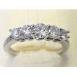 An 18ct white gold hallmarked diamond ring, the five brilliant cut claw set stones weighing a carat