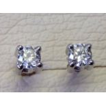 A pair of 18ct gold diamond stud earrings, the claw set brilliant cut diamonds