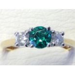 An 18ct yellow gold emerald & diamond three stone ring