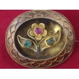 An oval 15 carat gold Victorian brooch with applied wire filigree decoration around a concave panel