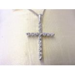 A platinum and diamond cross pendant, the crucifix set with sixteen diamonds, mounted on an 18ct