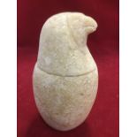 A carved Egyptian style vessel in the form of a bird with beaked cover above egg shaped jar