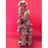 A Japanese carved hardwood figure, the bearded man holding staff & hat beside a small boy
